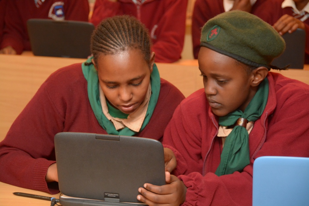 Students admiring a model classromm laptop that was unveiled by kenya private school association KPSA and Intel at an event held recently
